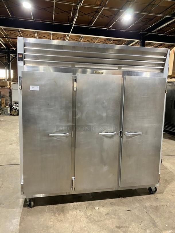 Traulsen G-Series 3-Door Stainless Steel Reach-In Freezer, Model G31011, with casters and poly-coated racks, SN: T14613A06.