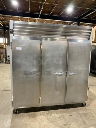 Traulsen G-Series 3-Door Stainless Steel Reach-In Freezer, Model G31011, with casters and poly-coated racks, SN: T14613A06.