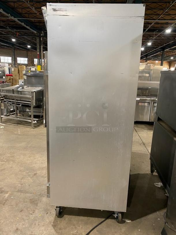 Traulsen G-Series 3-door stainless steel reach-in freezer, model G31011, with poly-coated racks, on casters, 115V 1 phase.