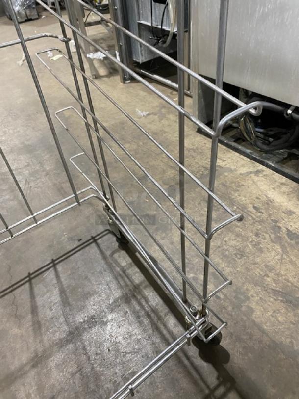 Commercial steel flat wire bread rack on casters, durable construction, metallic finish, excellent condition.