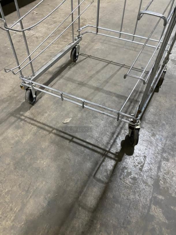 Commercial steel flat wire bread rack on casters, used condition. Sturdy metal frame, ideal for bakery use with easy mobility.