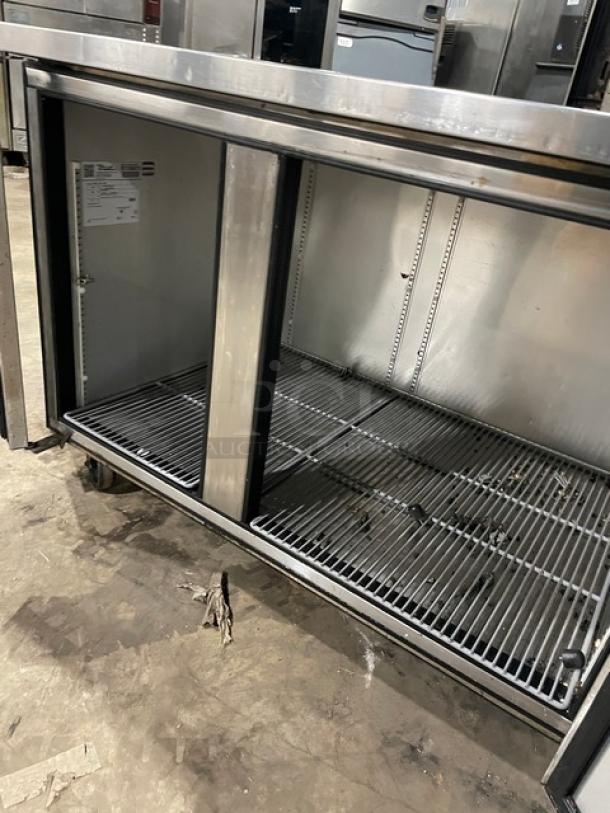 True TUC-60-32 commercial stainless steel 2-door worktop refrigerator with poly coated wired rack, on casters. Model TUC6032.