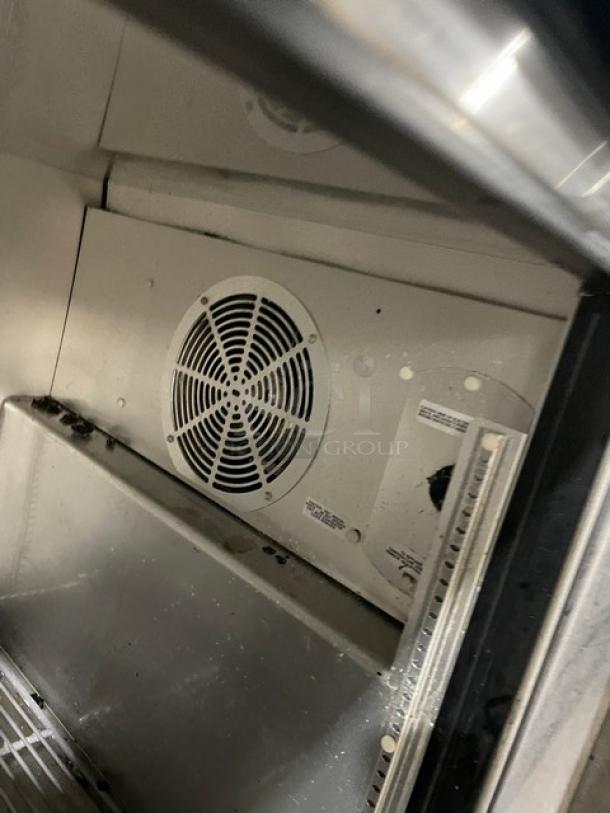 True TUC-6032 60" stainless steel 2-door undercounter refrigerator interior, showing poly-coated wired rack and fan unit.