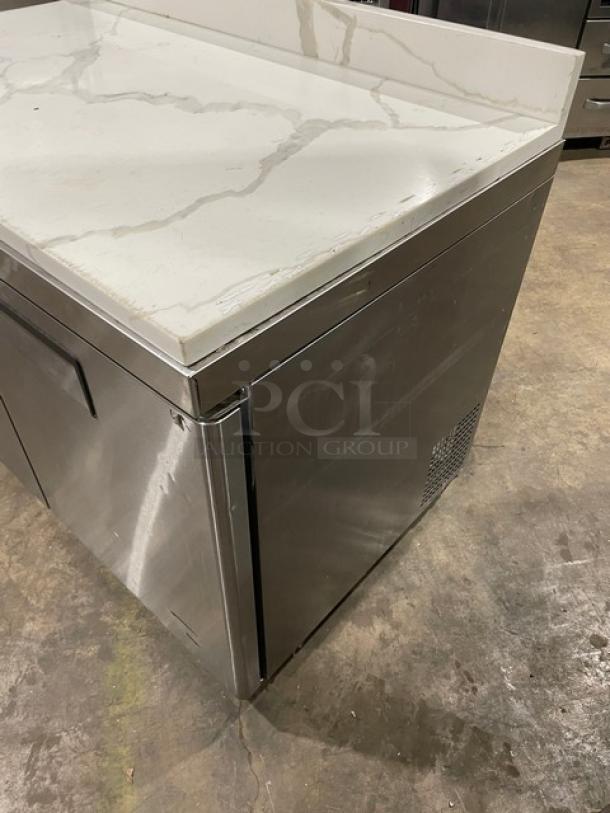 Atosa 2022 commercial stainless steel 2-door undercounter worktop freezer, model MGF8406GR, with marble style top and backsplash.