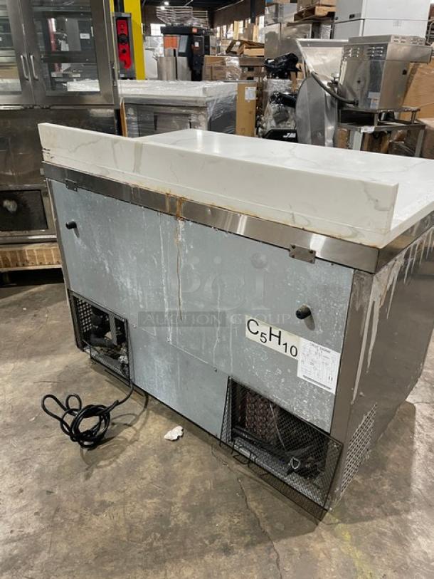 Atosa MGF8406GR 2022 commercial stainless steel 2-door undercounter freezer with marble-style worktop, backsplash, on casters.