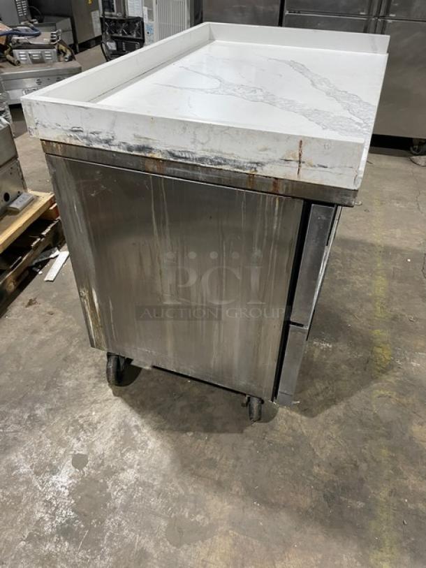 True TUC-48F-D-4-HC stainless steel freezer with marble-style top, upturned splash, four drawers, casters; used condition.