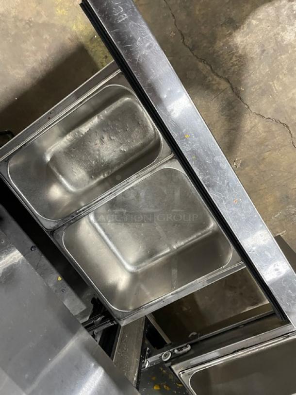 True TUC-48F-D-4-HC stainless steel 4-drawer undercounter freezer, marble-style worktop, upturned splash, on casters.