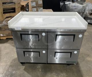 True commercial stainless steel 4-drawer undercounter freezer with marble-style worktop and upturned splash, model TUC-48F-D-4-HC.