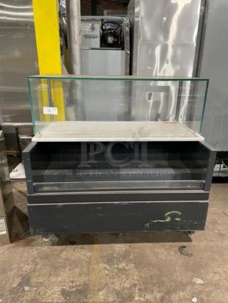 Structural Concepts black multi-level refrigerated open merchandiser display case with upper enclosed glass showcase.