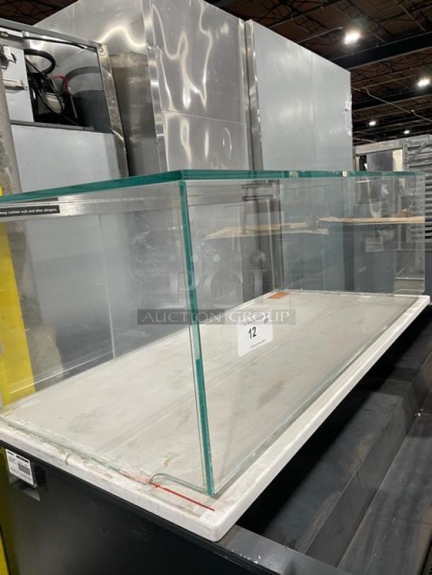 Structural Concepts commercial black multi-level refrigerated display case with upper glass merchandiser, on legs.