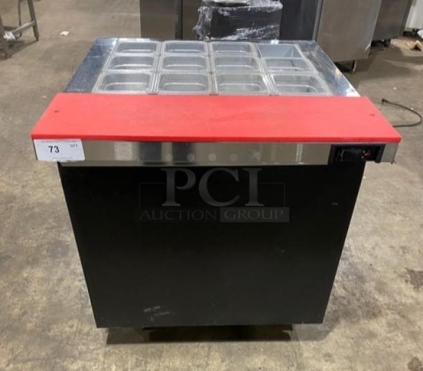 Continental SW32-12M black single door refrigerated prep table with red cutting board, clear food pans, and casters.