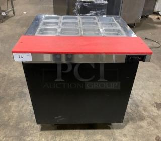 Continental SW32-12M black single door refrigerated prep table with red cutting board, clear food pans, and casters.