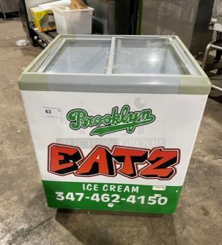 Commercial Brooklyn Eatz 28" ice cream display freezer, dual top sliding glass lid, on casters, 110V, white, good condition.