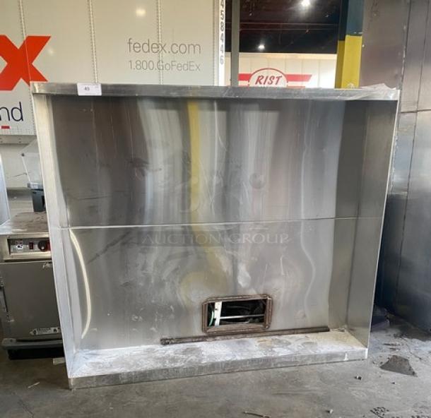 Commercial stainless steel kitchen exhaust hood, large size, durable material, used condition, opening for ventilation.