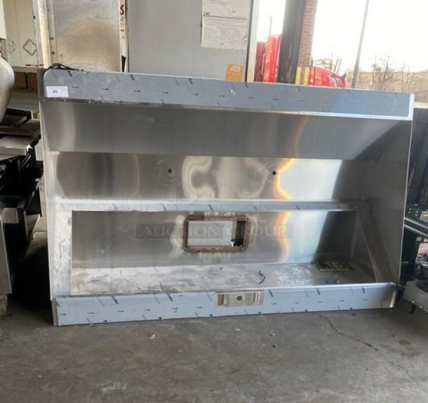 Commercial stainless steel kitchen exhaust hood, used condition. Visible vent opening, sturdy construction, ideal for restaurant use.