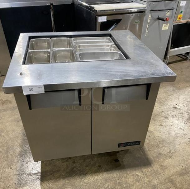 True Commercial Stainless Steel 2-Door Refrigerated Prep Table, Model TSSU-36-12M-B, on casters, with hotel pan compartments.