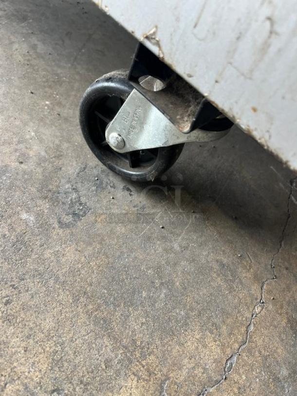 Beverage-Air commercial stainless steel reach-in freezer on caster. Model KF24-1AS. Poly coated wire rack inside.