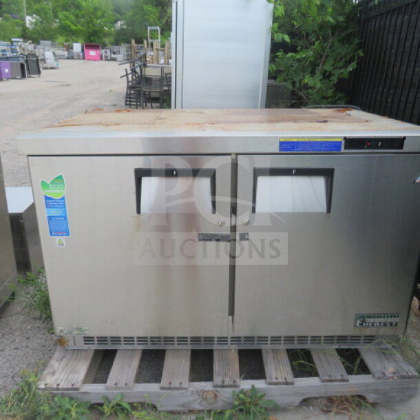 Everest ETBF2 undercounter freezer on casters, 48x31.5x36 inches, working condition, 115V, visible model and eco-friendly labels.