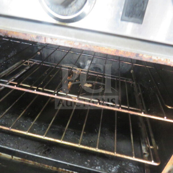 One Southbend 10 burner natural gas range Model S60DD, includes stainless steel overshelf and 4 racks.