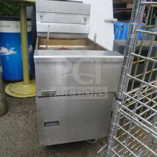 Pitco SG18 natural gas fryer on casters, 65lb capacity, stainless steel, visible wear, 19.5x34x43.5 inches.