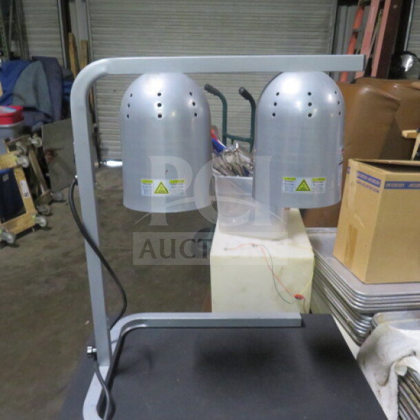 Winco food warmer, model EHL-2C, dual bulb, 120V. Silver finish, good condition, visible safety labels.