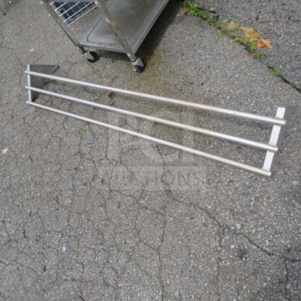 Stainless steel wall mount pot rack, 63x11x9 inches, three bars, durable construction, gently used condition.