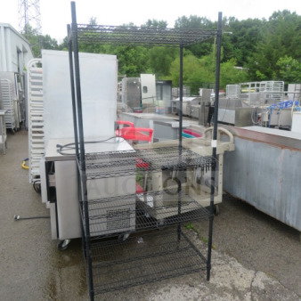 Black Metro shelf unit with four wire shelves, measures 36x24x75 inches. Used condition, sturdy storage solution.
