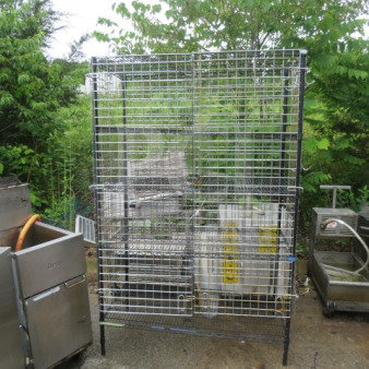 Metro shelf/cage with 5 wire shelves, 48x24x75 inches. Sturdy metal construction, suitable for storage. Outdoor setting.