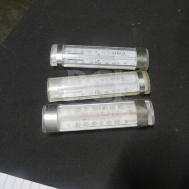 Three cylindrical thermometers, model 3XBID, in clear casings, displaying temperature scales; good condition.