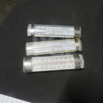 Three cylindrical thermometers, model 3XBID, in clear casings, displaying temperature scales; good condition.