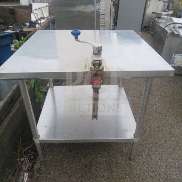 Stainless steel table with undershelf and Edlund 10lb can opener, 36x36x34 inches, used condition.