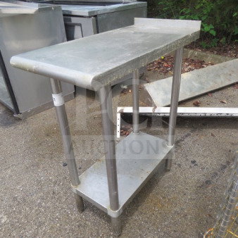 Stainless steel table with under shelf, measuring 15x30x36 inches. Features sturdy legs, ideal for commercial use.
