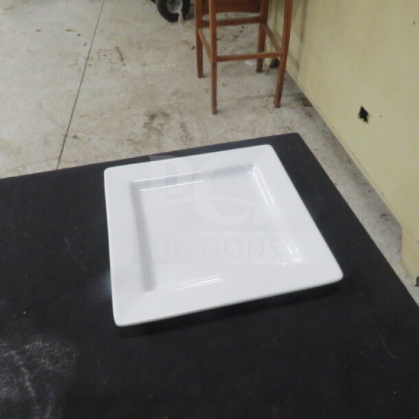 9-inch square white plate by World, model 12XBID, in excellent condition.