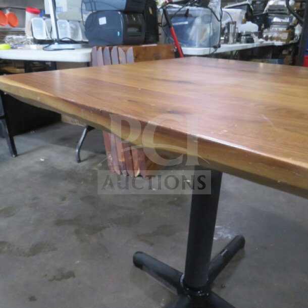 Solid wooden table, 2-inch thick top on pedestal base, 36x36x30 inches. Natural finish, good condition.