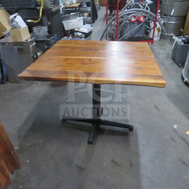 Solid wooden table top, 2-inch thick, on pedestal base, 36x36x30 inches, excellent condition.