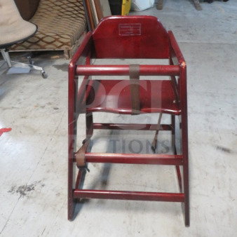 Wooden high chair with safety straps, sturdy construction, moderate wear. Suitable for toddlers. 