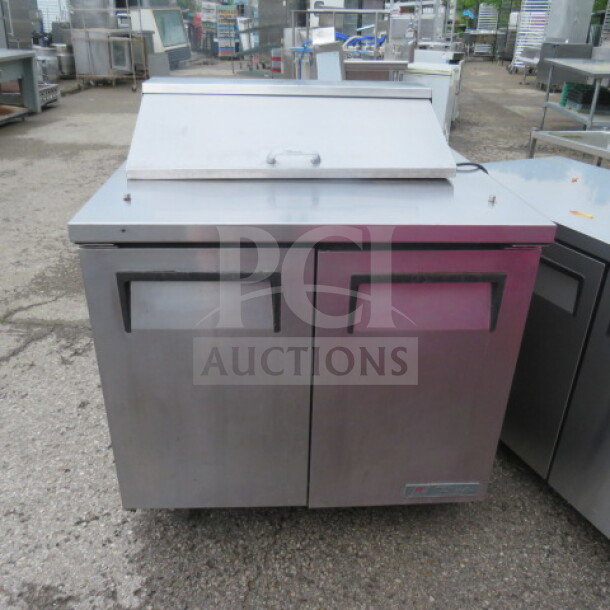 True TSSU-36-08 refrigerated prep table, two doors, one rack, on casters. Working condition, 115V, 36x30x43 inches.