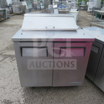 True TSSU-36-08 refrigerated prep table, two doors, one rack, on casters. Working condition, 115V, 36x30x43 inches.