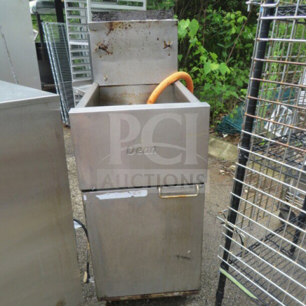 Dean natural gas deep fryer, model SR152GN, on casters. Dimensions: 15.5x29x47 inches. Worn exterior, visible logo.