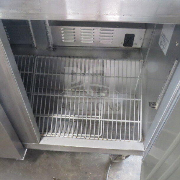 Hoshizaki 3 Door Refrigerated Prep Table, Model CRMR72-30M, with 2 racks, on casters. Interior view, excellent condition.