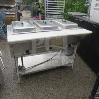 One 3 well electric steam table with stainless steel under shelf and cutting board, dimensions 46x30x34, in used condition.