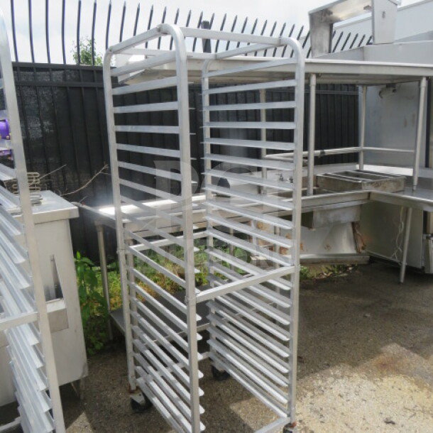 Aluminum speed rack on casters, 20.5x26x70 inches, used condition, multiple shelves, ideal for kitchen storage or transport.