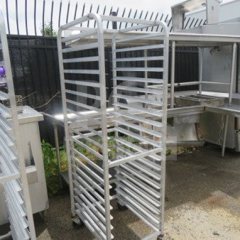 Aluminum speed rack on casters, 20.5x26x70 inches, used condition, multiple shelves, ideal for kitchen storage or transport.