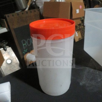 Store N Pour container with orange lid, used condition. Ideal for storage and pouring. Some wear visible.