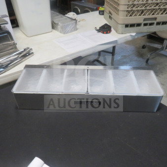 "One Glastender domed bar center, stainless steel, segmented compartments, brand logo visible, excellent condition."