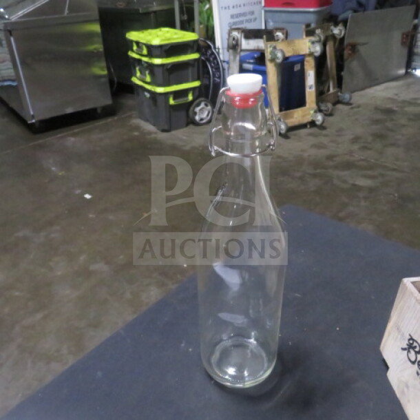 Hinged lid water bottle, transparent glass, secure metal clasp, white and red top, good condition, model 5XBID.