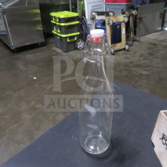 Glass water bottle with hinged lid, model 5XBID. Clear body, red and white cap. Excellent condition, ideal for storage.

