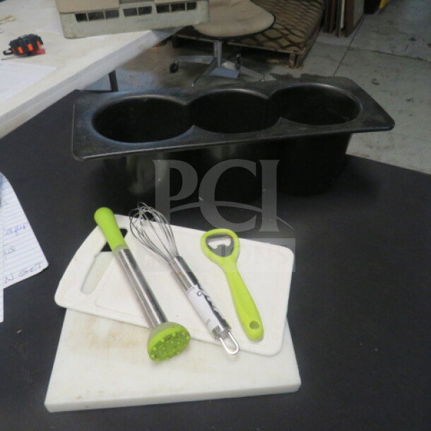Lot of barware includes a black ice bin, metal whisk, green bottle opener, muddler, and cutting board. Good condition.