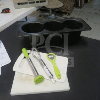 Lot of barware includes a black ice bin, metal whisk, green bottle opener, muddler, and cutting board. Good condition.