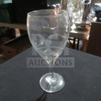 Clear stem wine glass with a round base, slightly used condition, labeled "12XBID."